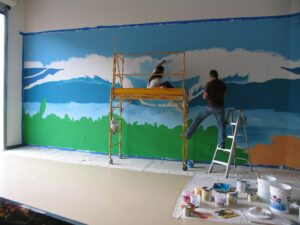 Drew & Heather painting a wall mural